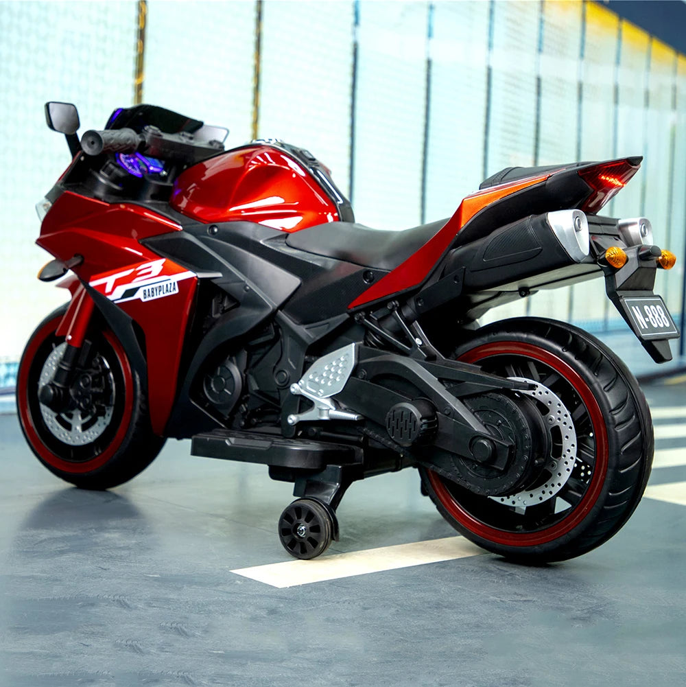 Red and black motorcycle on a concrete surface with blurred background