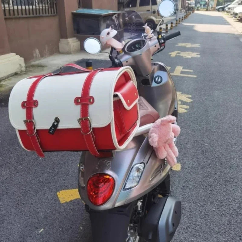 Durable 33L waterproof luggage bag mounted on a Vespa scooter for travel.