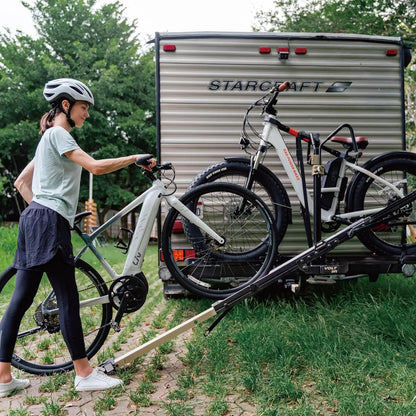 Lift-assisted hitch-mounted RV e-bike rack with ramp, carrying two fat tire electric bikes