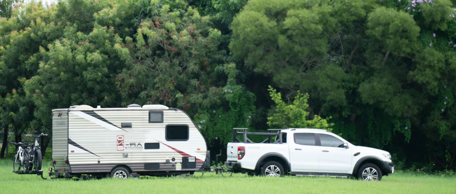 Lift-assisted hitch-mounted RV e-bike rack with ramp, carrying two fat tire electric bikes